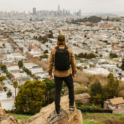 GoRuck GR1 a man with a backpack on a hill