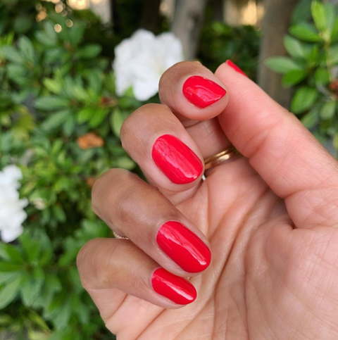 a simple red mani with a floral background