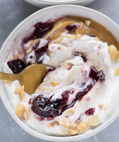 yogurt bowl with peanut butter and jelly with gold spoon