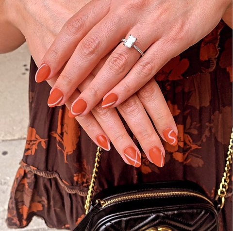 burnt orange nails with subtle beige accents