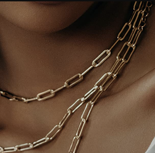 a model wears a gold chain necklace in a roundup of the best minimalist jewelry on amazon 2022