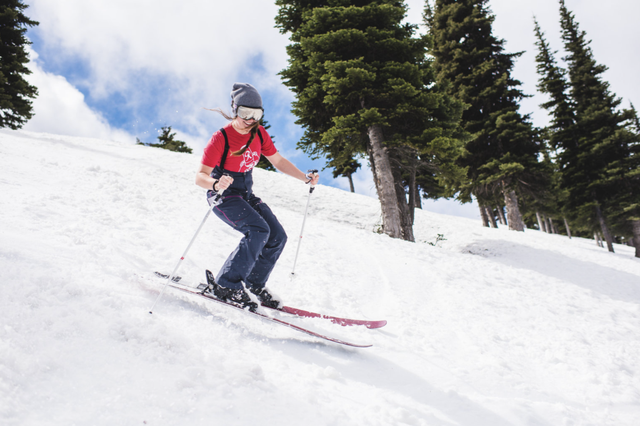 a woman in short sleeves enjoys spring skiing
