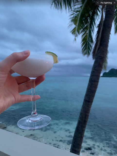 a coconut margarita in a couple glass, overlooking the ocean