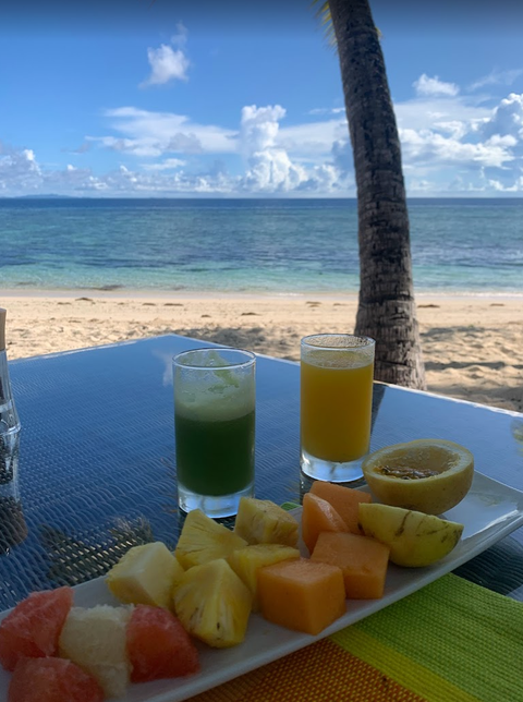 fruit on a platter, with a view of the beach