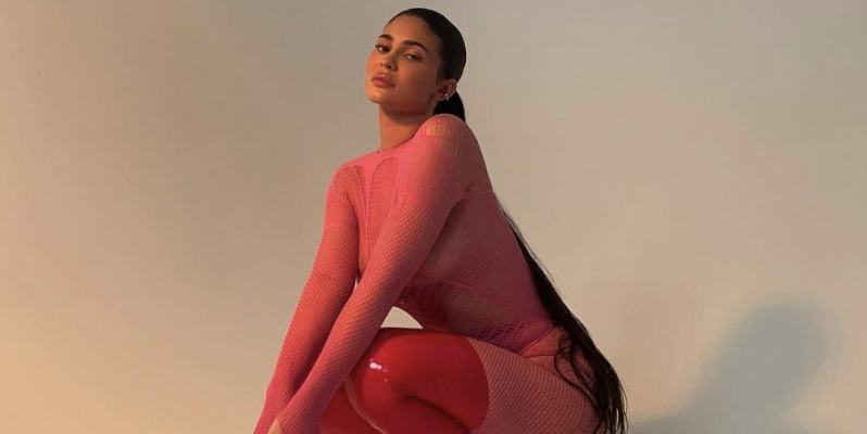 Kylie Jenner Poses in Hot Pink Fishnet Catsuit & Thigh-High Boots