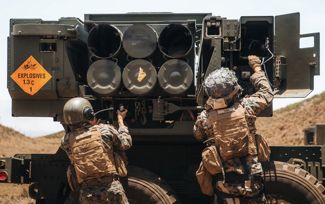 marine corps cpl juan del haro and sgt mauricio sosa load a high mobility artillery rocket system during rim of the pacific 2022 at pohakuloa training area, hawaii, july 18