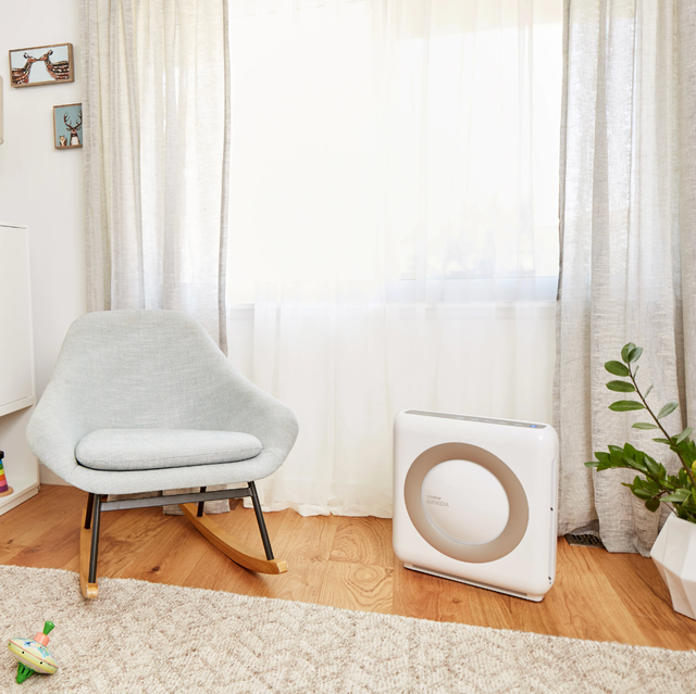coway air purifier next to chair