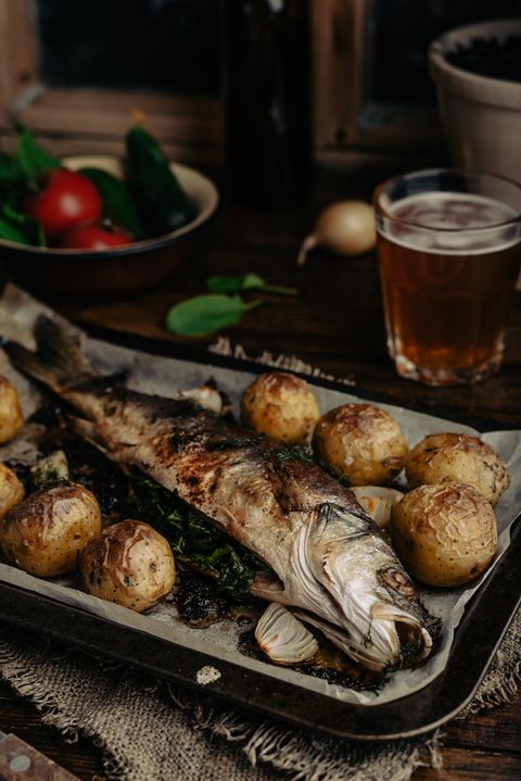 sea bass baked with new potatoes and onion