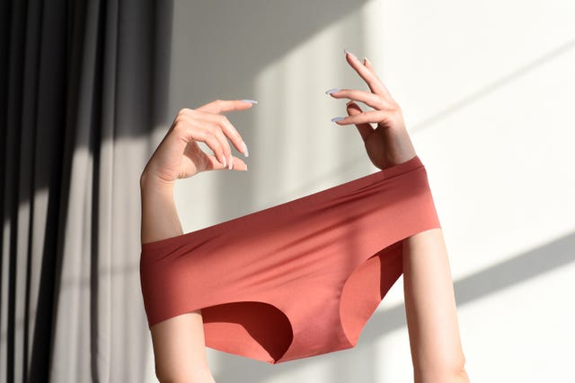 Seamless female panties in the hands of the girl. アーユルヴェーダ