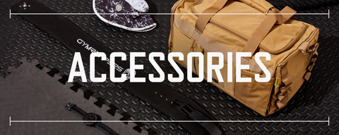 multiple gym accessory pieces laid out on black rubber gym flooring with text saying accessories laid over top the photo