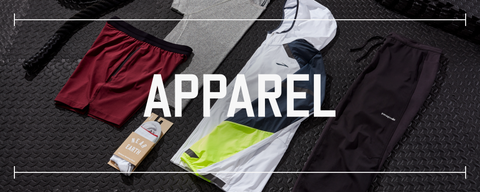 multiple pieces of fitness apparel knolled out on top of black rubber gym flooring with text saying apparel over top the photo