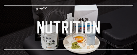 multiple types of fitness supplements laid out on black rubber gym flooring with text saying nutrition laid over top the photo