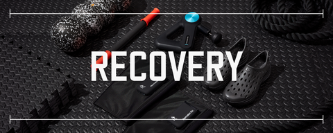 several pieces of fitness recovery equipment in various colors placed on a black rubber gym floor with text saying recovery placed above the photo