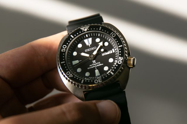seiko dive watch held in hand