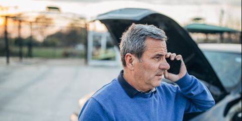 senior man calling on cellphone for car service