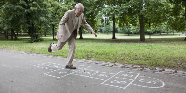 senior man playing hopscotch in the park