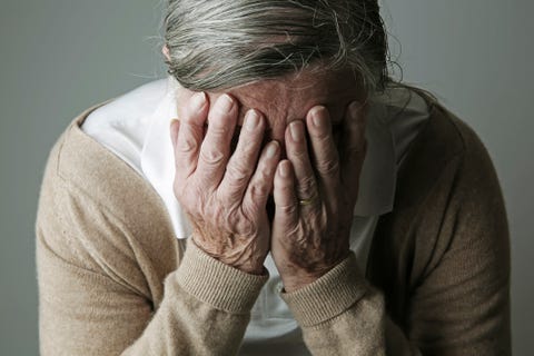 Senior woman covering face with her hands