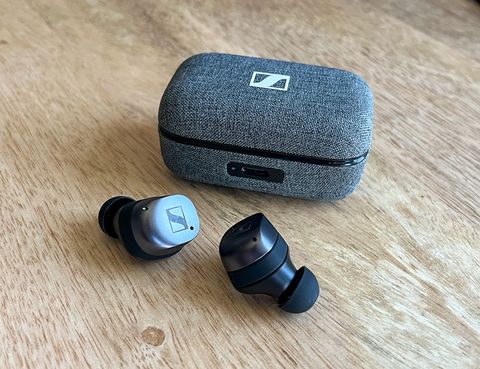 sennheiser momentum true wireless 3 earbuds sitting on a table next to case