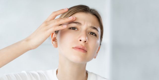 sensitive skin acne problem woman touching face