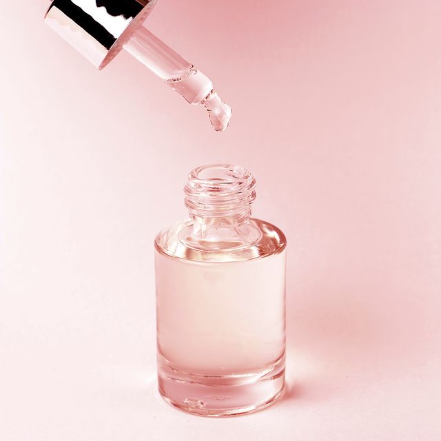 serum and dropper on a pink background close up, natural cosmetics concept