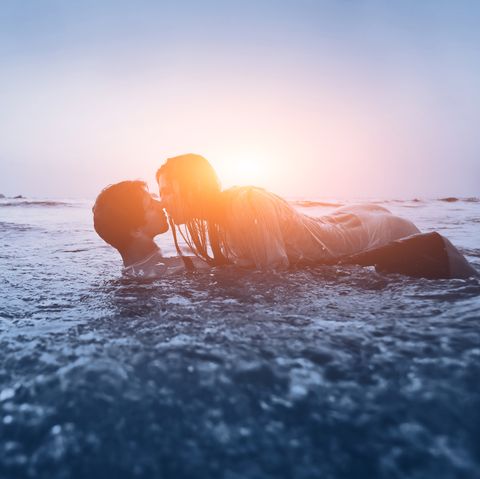 sexy couple kissing in ocean