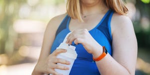 woman drinking from shaker bottle 