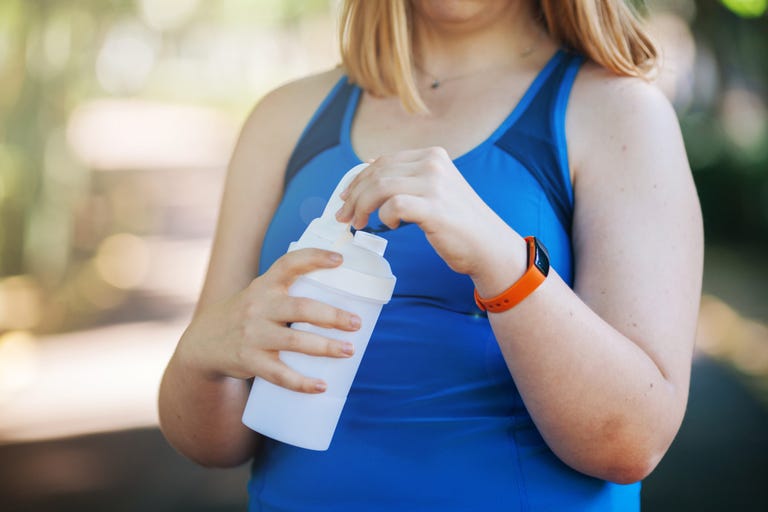 woman drinking from shaker bottle 