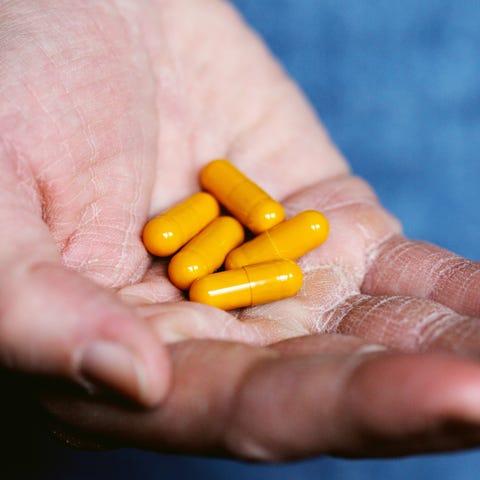holding yellow pills