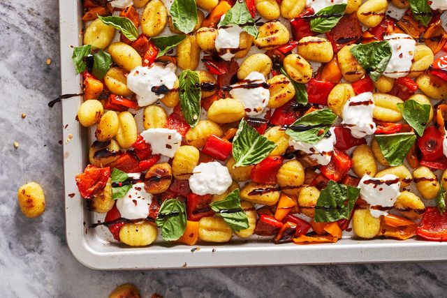 sheet pan roasted gnocchi and peppers topped with burrata, basil and balsamic reduction