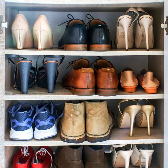 heels boots sneakers on shelves in shoe cabinet