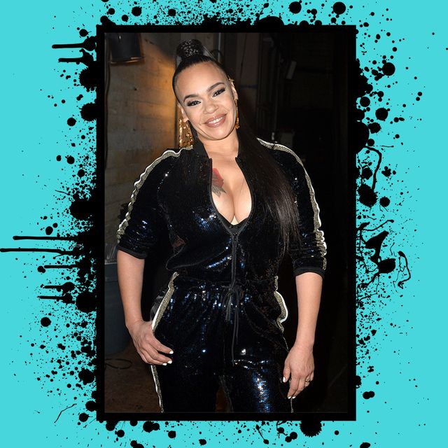 dressed in a black jumpsuit, faith evans poses for the cameras