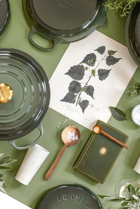 a table with plates and bowls from le creuset