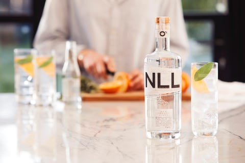bottle of non alcoholic gin next to mixed beverage