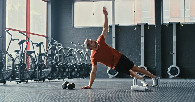 shot of a mature man working out in the gym during the day
