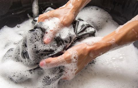 Hand washing soapy clothes