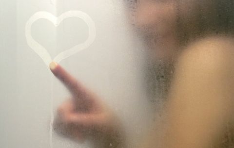 Drawing heart in fog on shower door
