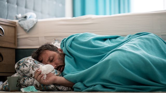sick man with fever on ground in bedroom