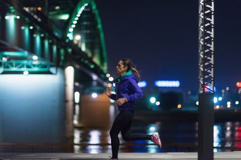 Side View Of Woman Running By River At Night