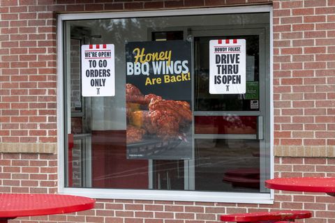 sign in the window of a kfc fast food restaurant telling customers only the drive thru is open for to go orders because of the coronavirus epidemic, vadnais heights, minnesota