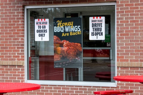 sign in the window of a kfc fast food restaurant telling customers only the drive thru is open for to go orders because of the coronavirus epidemic, vadnais heights, minnesota