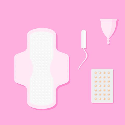 Menstrual pad, tampon, reusable period cup and hot water bottle on pink surface.