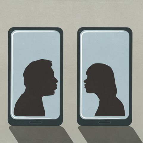 silhouette couple kissing on separate smart phone screens