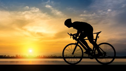 Silhouette Man Riding Bicycle Against Sky During Sunset