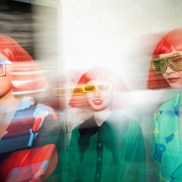 backstage fashion show models wearing red wig with glass sunglasses