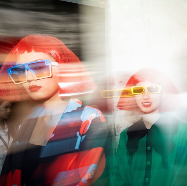 backstage fashion show models wearing red wig with glass sunglasses