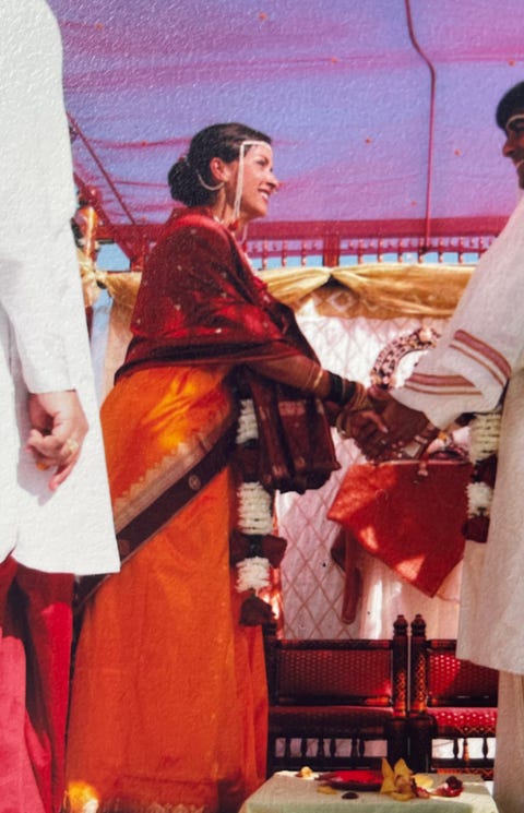 the author clasps hands with her new husband during their wedding