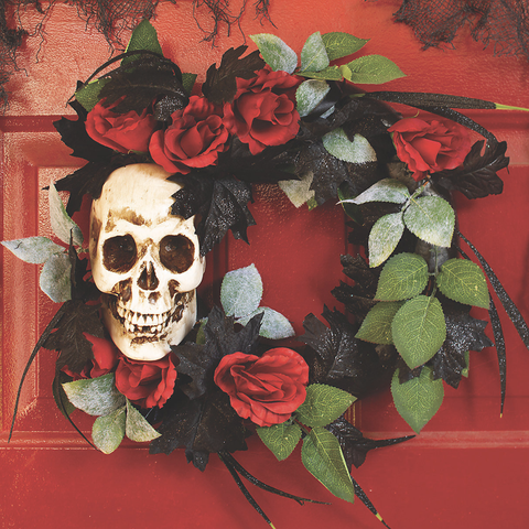 wreath with skull, red roses, black glitter leaves, and some green leaves
