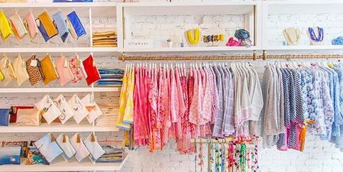 Room, Pink, Clothes hanger, Textile, Footwear, Shelf, Interior design, Furniture, Boutique, Outlet store, 