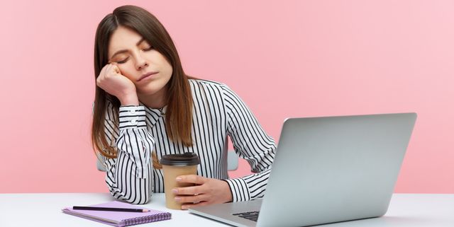sleepy inefficient woman office worker napping leaning head on hand and holding coffee cup sitting at workplace with laptop, physical exhaustion