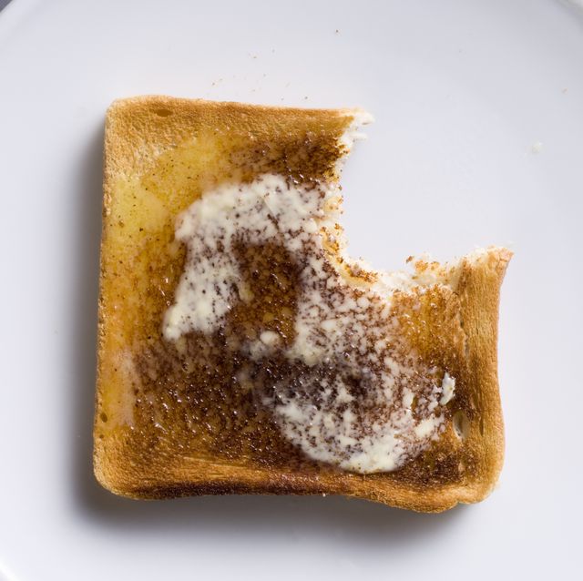 slice of hot buttered toast with a bite taken out